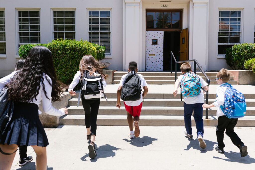 Kids with backpacks heading to school after parents completed back to school house cleaning